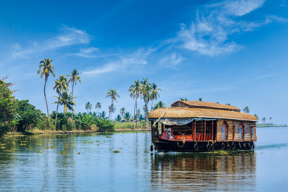 A traditional Kerala houseboat on the palm-lined backwaters of Alleppey